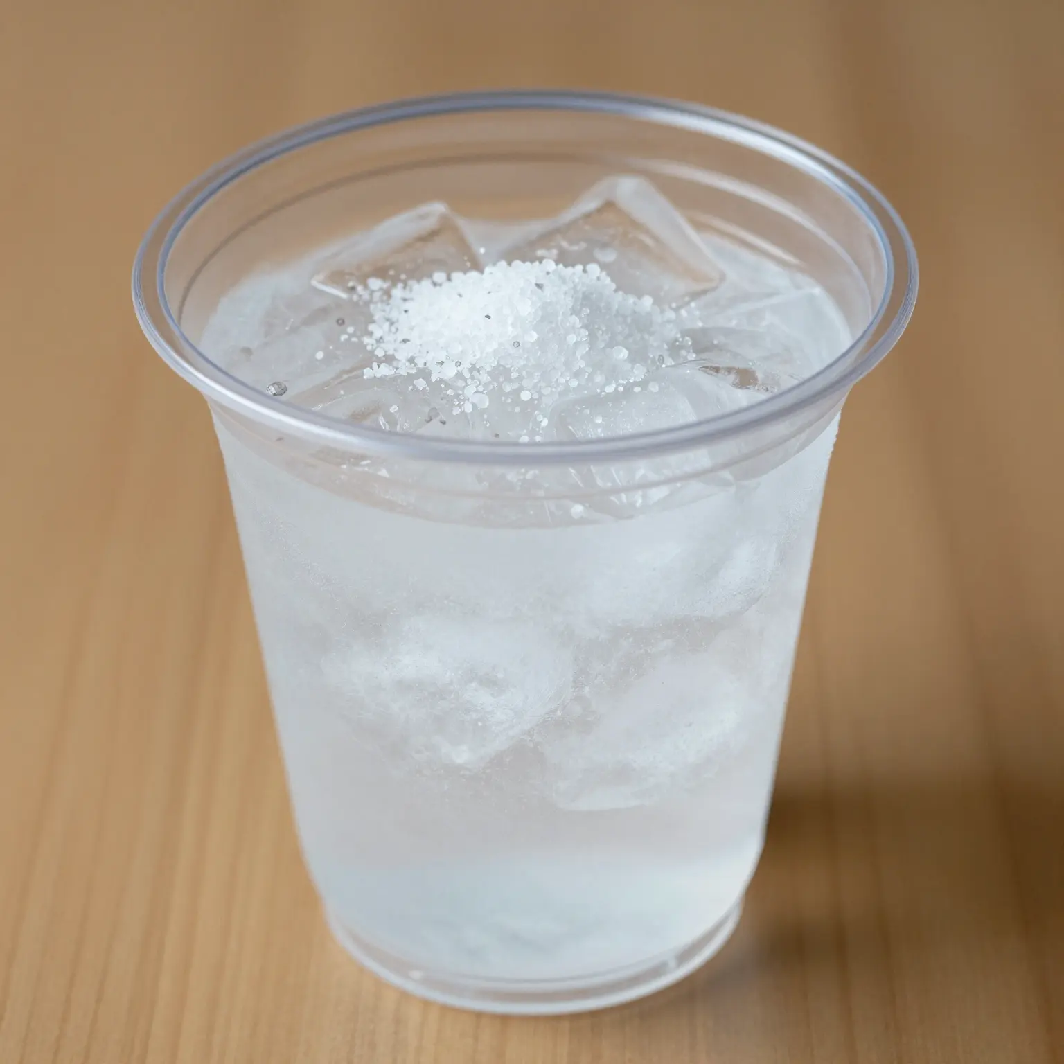 Plastic cup filled with ice and salt